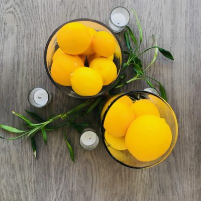 meyer lemons in vase with candles